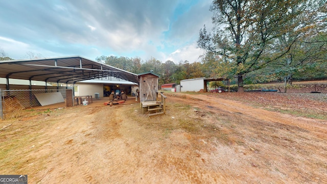 view of yard featuring an outbuilding and a carport