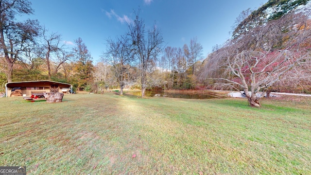 view of yard with a water view and a carport