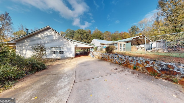 view of side of property featuring a carport