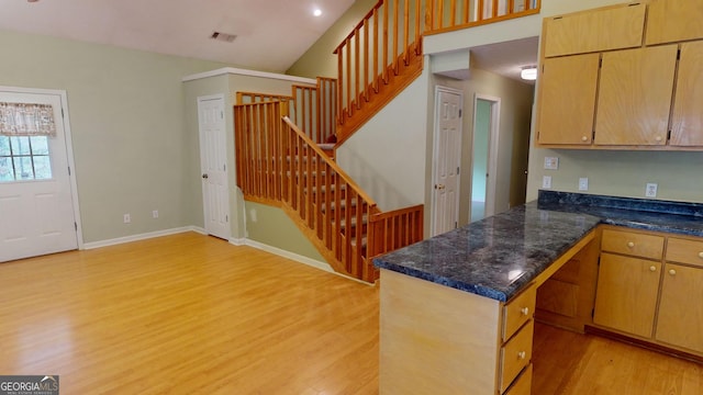 kitchen featuring kitchen peninsula and light hardwood / wood-style floors