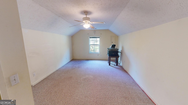 bonus room with a textured ceiling, light carpet, ceiling fan, and vaulted ceiling