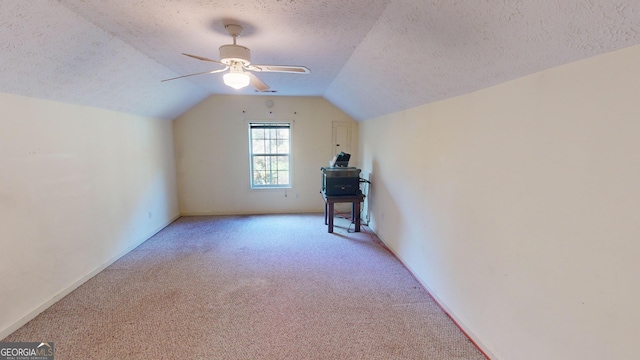 bonus room featuring ceiling fan, a textured ceiling, light carpet, and vaulted ceiling