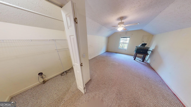 bonus room featuring a textured ceiling, light carpet, and vaulted ceiling