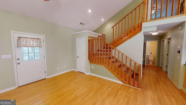 foyer entrance featuring hardwood / wood-style floors and vaulted ceiling