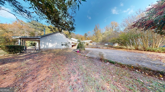 view of home's exterior with a carport