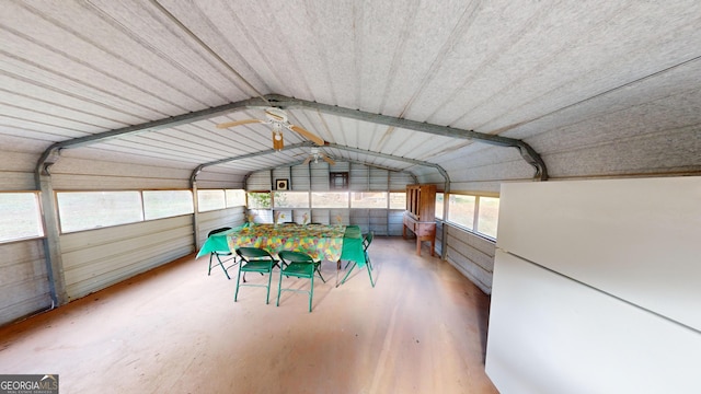 unfurnished sunroom with ceiling fan and vaulted ceiling