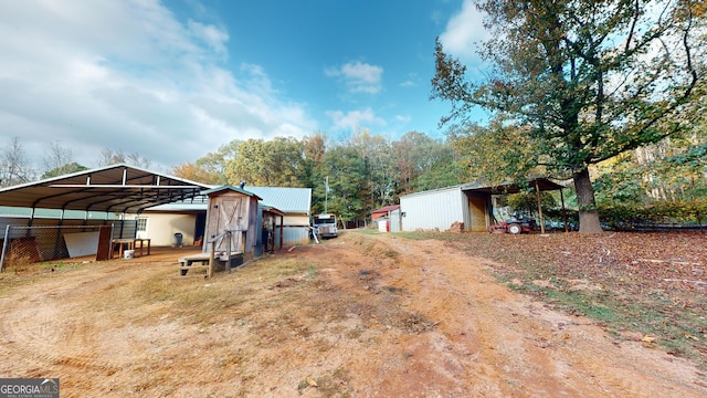 view of yard with an outbuilding and a carport