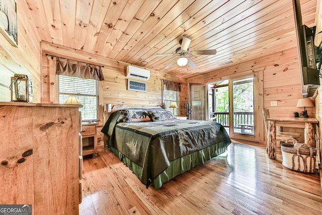 bedroom with hardwood / wood-style floors, multiple windows, wooden walls, and a wall mounted air conditioner