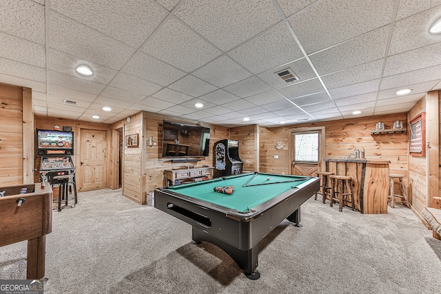 game room with pool table, wooden walls, and light carpet