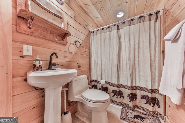 bathroom featuring toilet, wood ceiling, tile patterned flooring, wood walls, and walk in shower