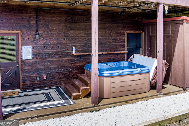 wooden terrace featuring a hot tub