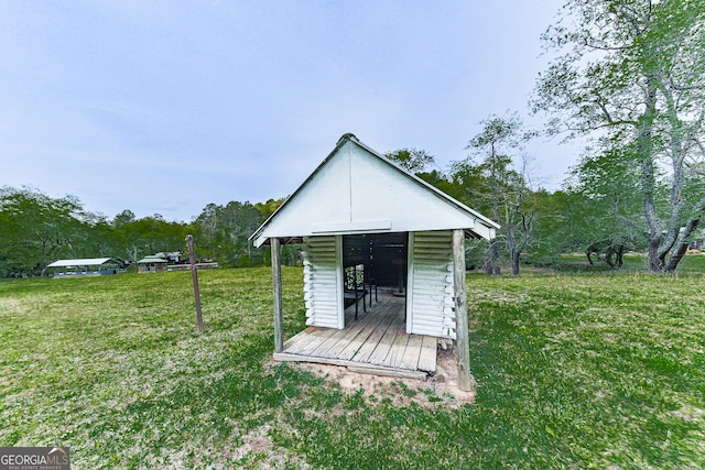 view of outbuilding featuring a yard