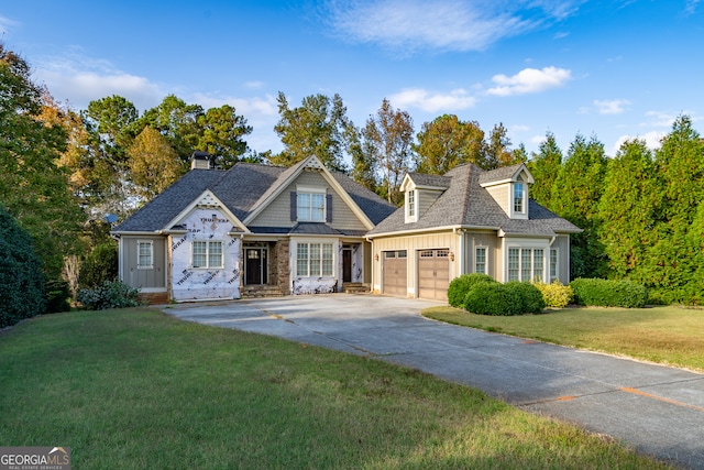 view of front of house with a front yard and a garage