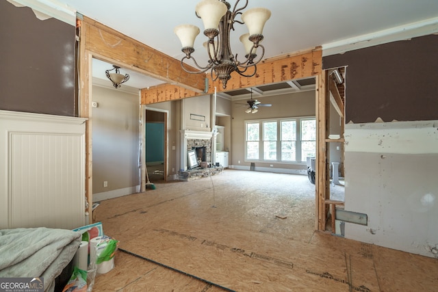 interior space with ceiling fan with notable chandelier and a fireplace