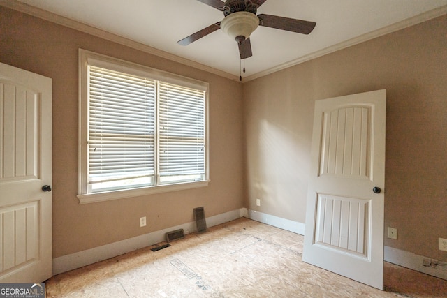 unfurnished room with ceiling fan and ornamental molding