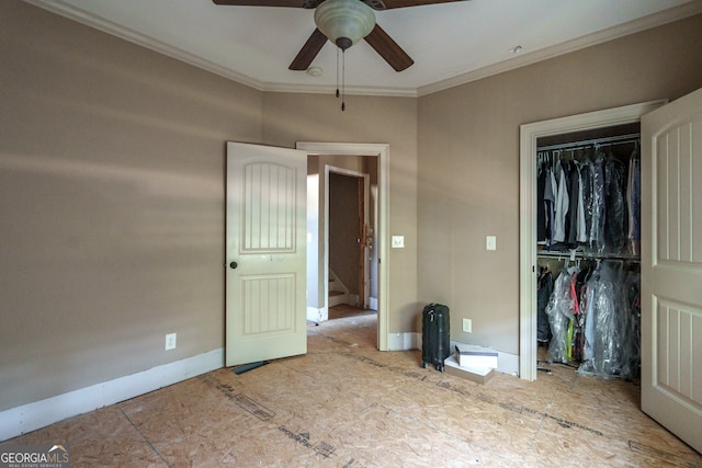 unfurnished bedroom with ornamental molding, ceiling fan, and a closet