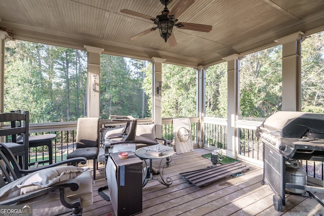 wooden deck featuring grilling area and ceiling fan