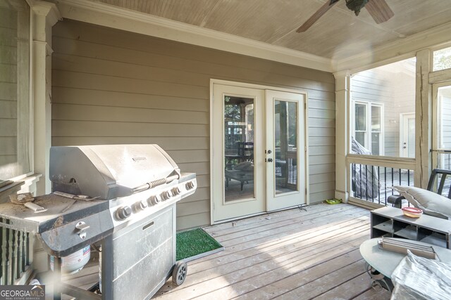 wooden deck featuring area for grilling and ceiling fan