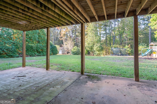 view of patio featuring a playground and a trampoline