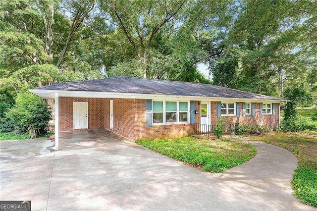 ranch-style house featuring a carport