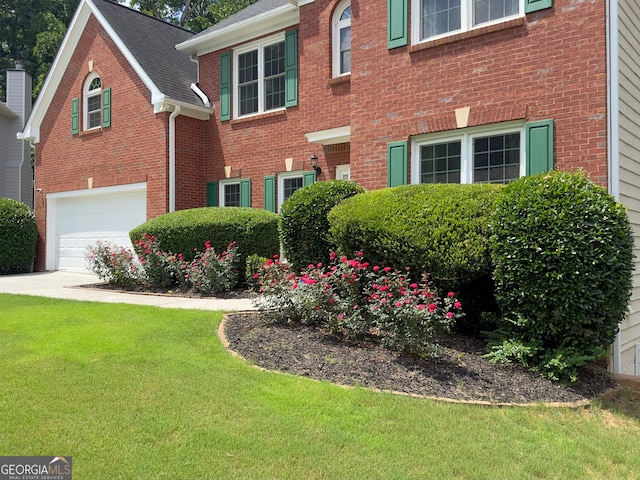 view of front of house featuring a garage and a front lawn