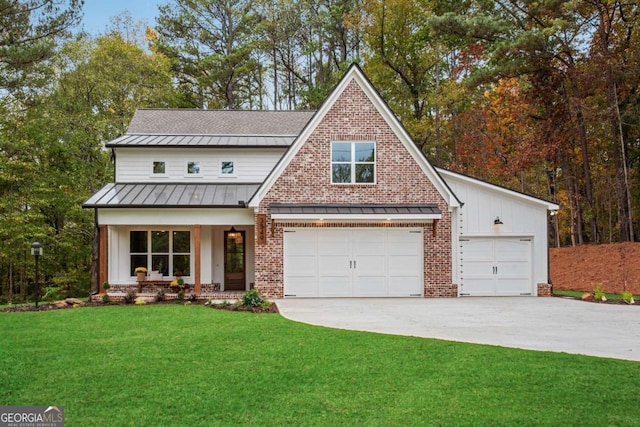 view of front of home with covered porch, a garage, and a front lawn