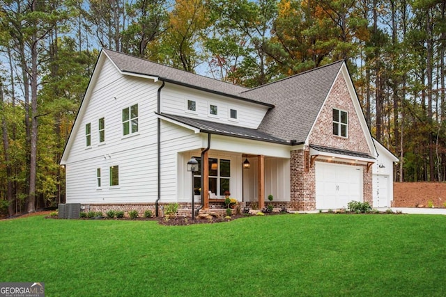 modern inspired farmhouse featuring a garage, a front yard, cooling unit, and a porch