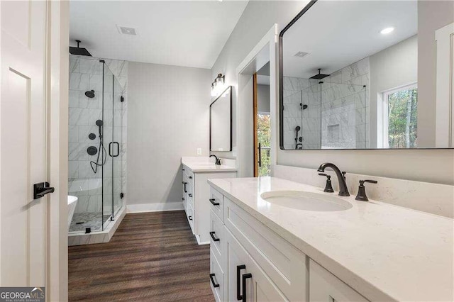 bathroom with vanity, wood-type flooring, and walk in shower