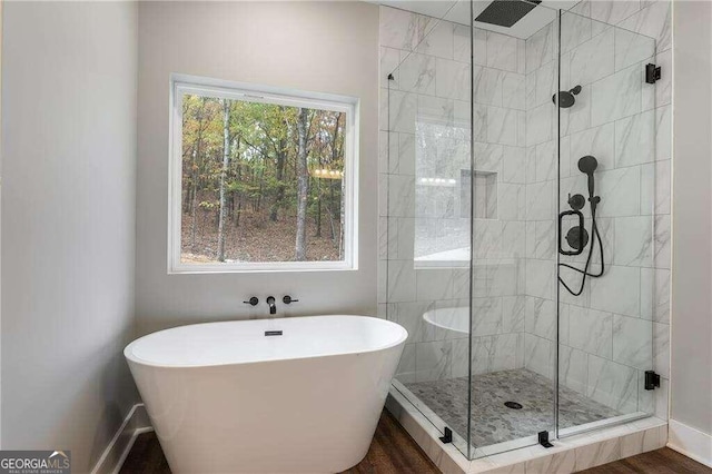 bathroom featuring hardwood / wood-style floors and shower with separate bathtub