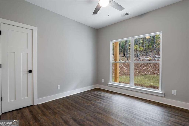 unfurnished room featuring ceiling fan and dark wood-type flooring