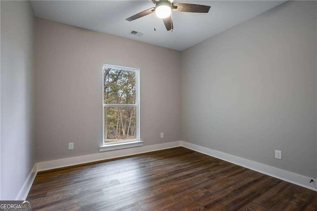 spare room with dark hardwood / wood-style flooring, plenty of natural light, and ceiling fan