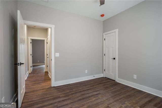 unfurnished room featuring dark hardwood / wood-style flooring