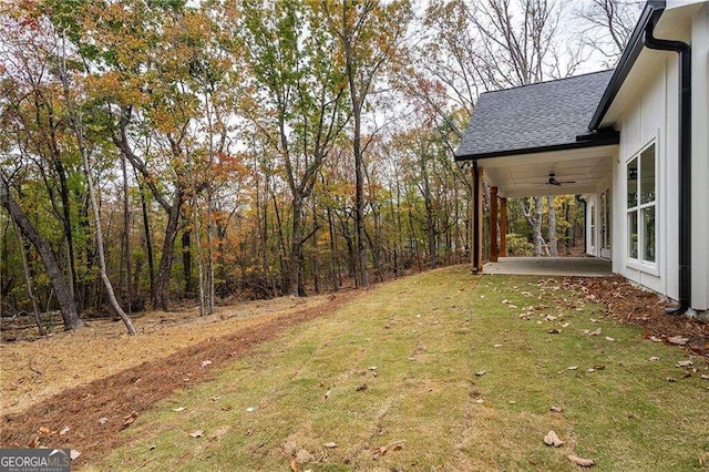 view of yard with ceiling fan and a patio area