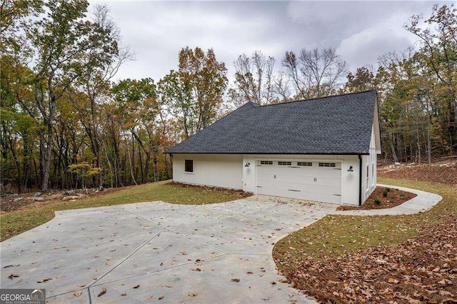 view of side of property with a garage and a yard