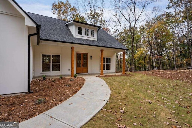 view of front of property with a front lawn and french doors