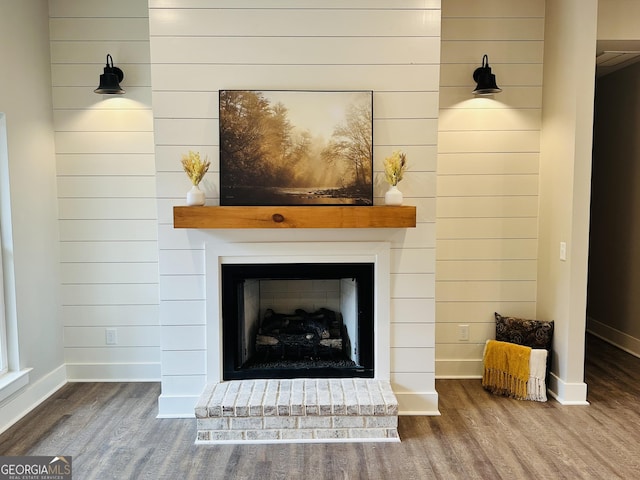 interior details with wooden walls and hardwood / wood-style floors