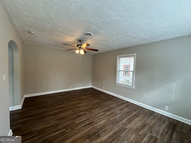 unfurnished room featuring dark wood-type flooring, a textured ceiling, and ceiling fan