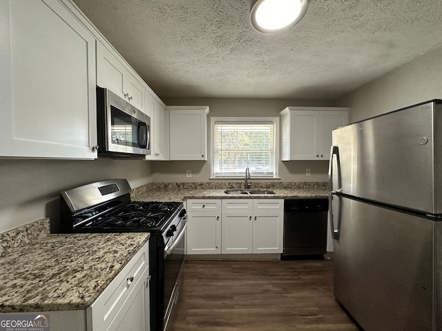 kitchen featuring dark wood-type flooring, white cabinetry, sink, and stainless steel appliances