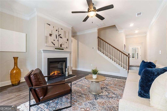 living room with ceiling fan, ornamental molding, and hardwood / wood-style flooring