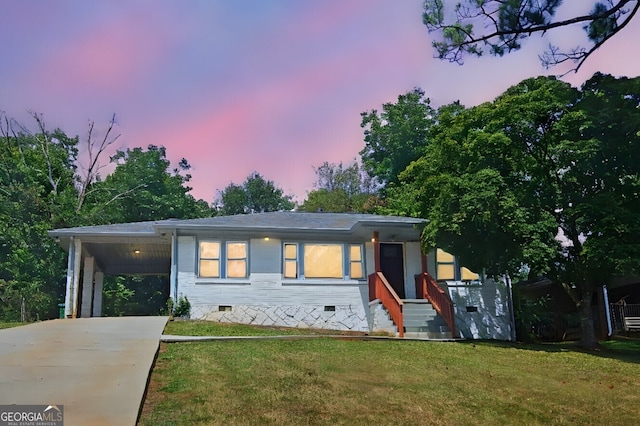 view of front facade featuring a yard and a carport