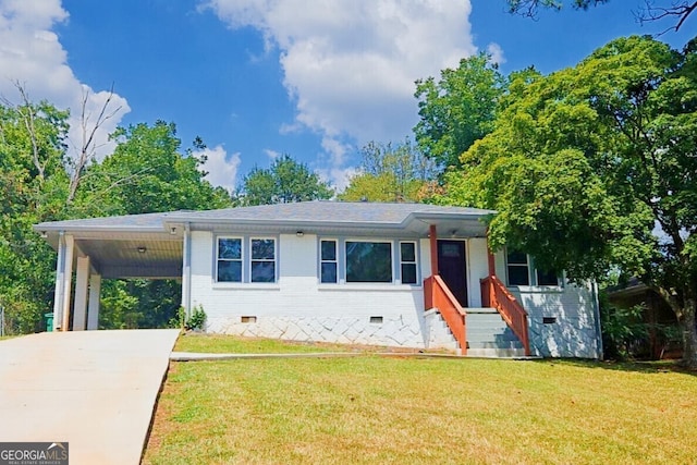 view of front facade with a front yard and a carport