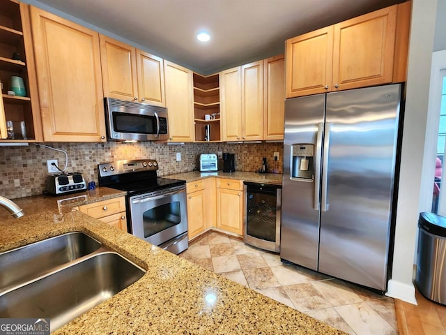 kitchen with light stone counters, decorative backsplash, sink, appliances with stainless steel finishes, and wine cooler