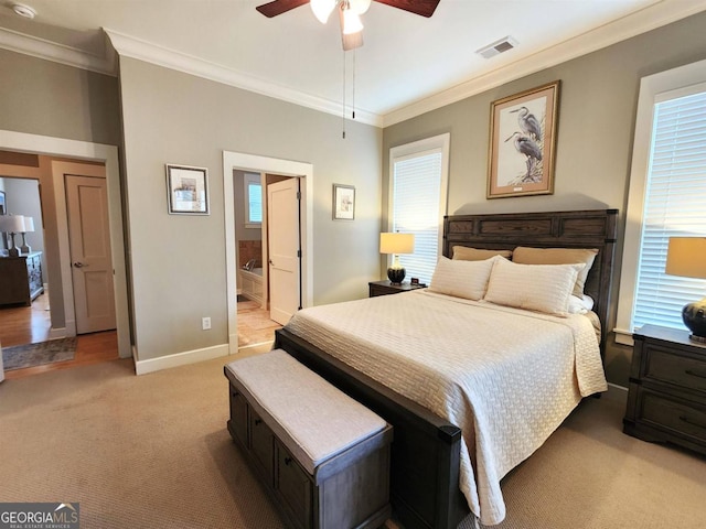 carpeted bedroom with connected bathroom, ceiling fan, and crown molding