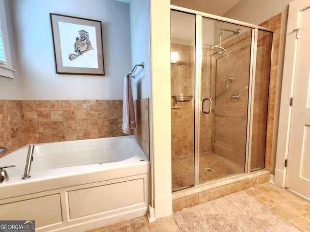 bathroom featuring independent shower and bath