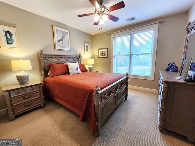 bedroom with light carpet and ceiling fan