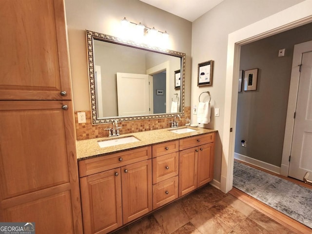 bathroom featuring vanity and tasteful backsplash