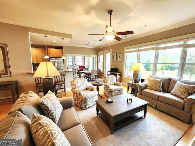 living room with ceiling fan, light hardwood / wood-style flooring, and crown molding