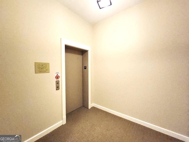 corridor with elevator and carpet