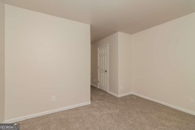 empty room featuring light carpet