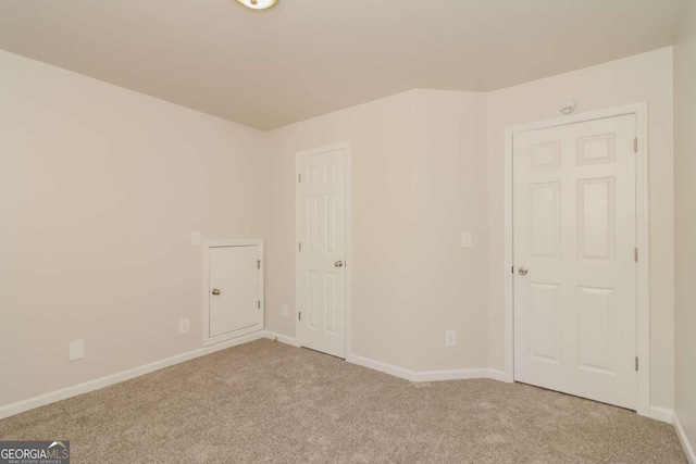 empty room featuring light carpet